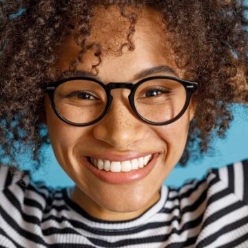 Joyful multiethnic female with red-dyed hair with Jell-O dip dye.