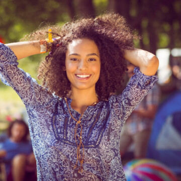 A cute black female with beautiful curls after shampooing her hair because corn starch sucks.