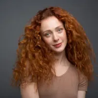 White woman with light brown hair dyed a lighter shade with Sun-In Hair Lightener