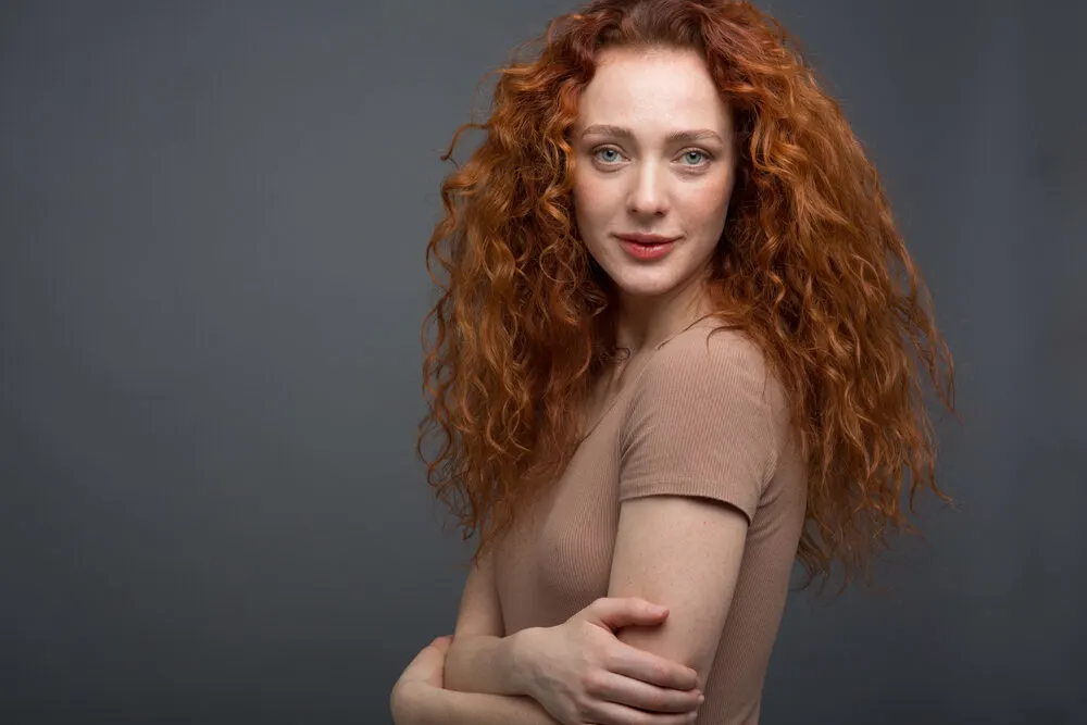 Lady with completely dry wavy hair wearing casual clothes and red lipstick.