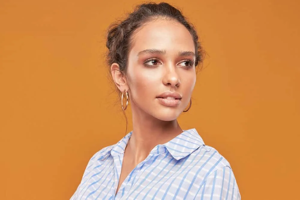 Light skinned curly girl with subtle make-up with an updo styled with leave-in conditioner and microfiber towel