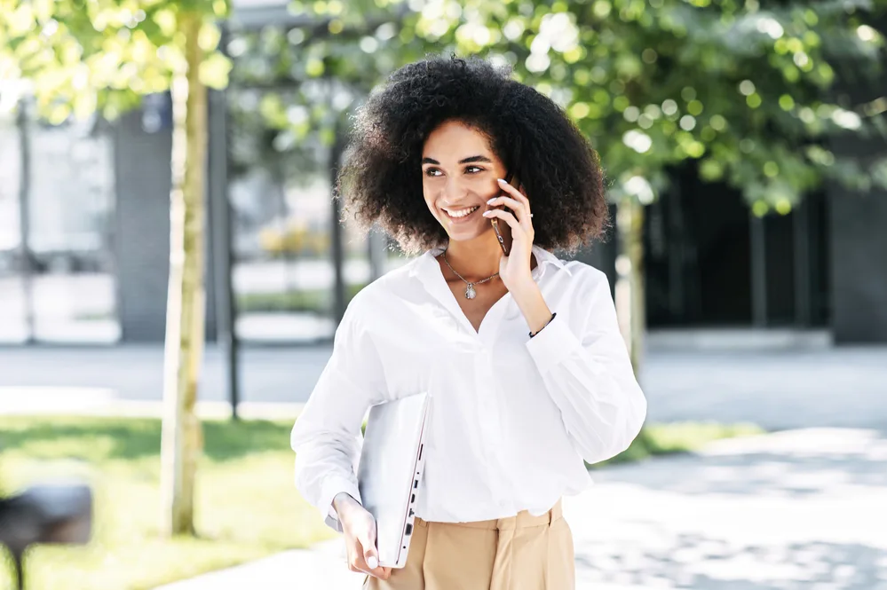 A beautiful African woman talking to a friend about female pattern hair loss and the passing hair growth cycle.