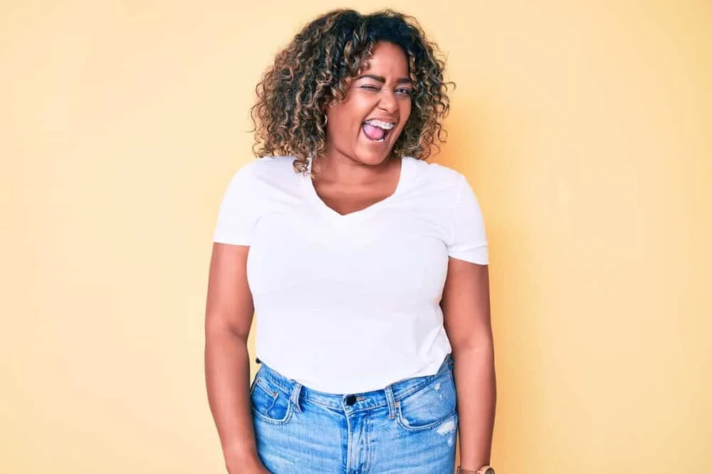 Black girl with braces with dark brown natural shade wearing casual weekend clothes.