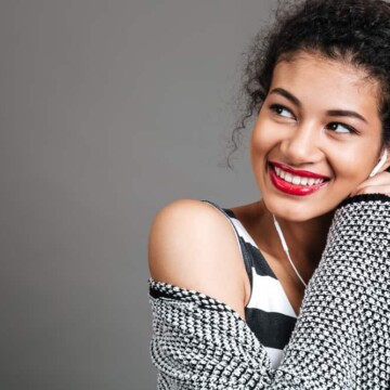 Cute light-skinned black girl with curly hair follicles styled with raw aloe vera juice to promote hair growth.