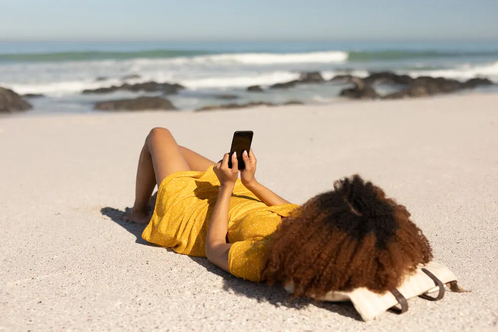 Gorgeous black girl that recently took down a protective style wearing a wash n go twist-out beach hairdo.