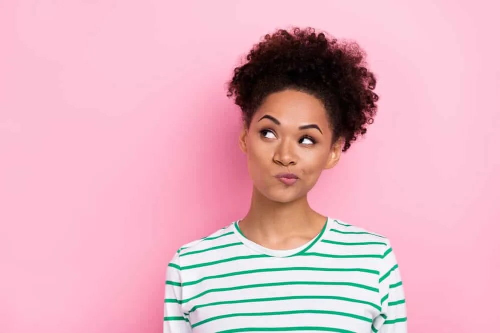 African American female with naturally curly hair wearing semi-permanent hair dye.