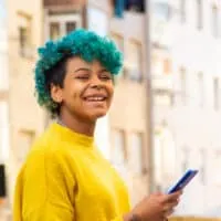 Young girl leaving a professional hair stylist with a blue hair color after a semi-permanent dye treatment.