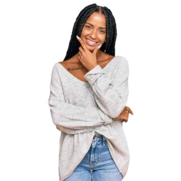 A beautiful Hispanic woman wearing braided hair across her entire head with a beige sweater.