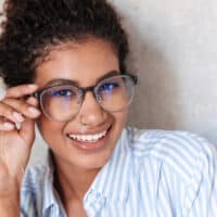 Cute African American female with 3B dark brown hair with highlights from a box dye.