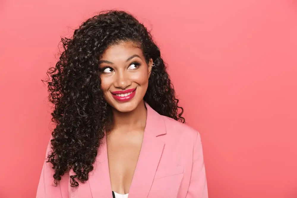 Beautiful African American lady with curly natural hair that has been colored with semi-permanent dye.