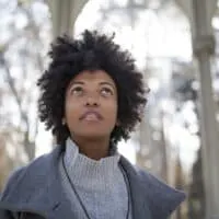 Gorgeous black female on an autumn day wearing a gray jacket with a mini afro styled with extra virgin coconut oil.