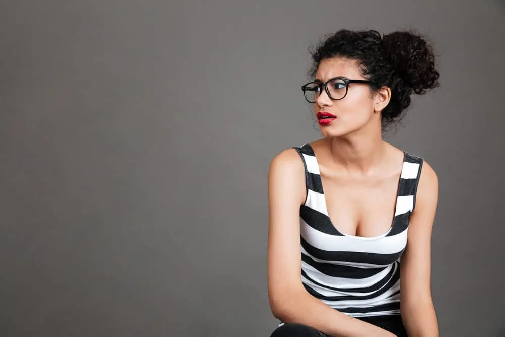 Mixed race black girl wearing a curly updo-styled aloe gel, castor oil, and olive oil.