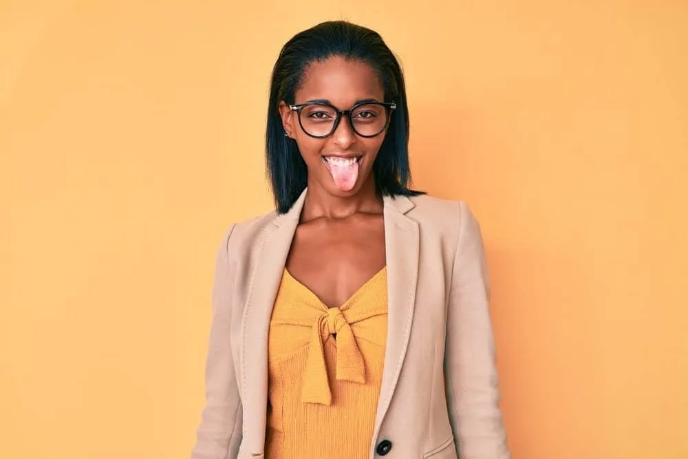 Young woman making a funny facial expression with relaxed hair from a Dominican Blowout.