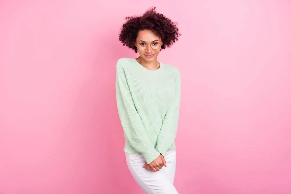 Charming black woman wearing a wash n go hairdo styled with essential hair oils.