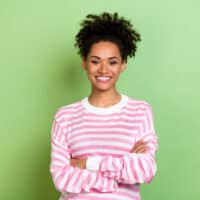 Cute African American female with color-treated hair follicles on 3C healthy hair after a salon treatment.