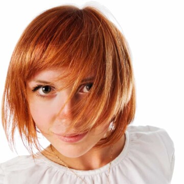 Beautiful young white female with a brassy orange hair color with a cute bob hairstyle.