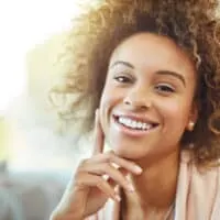 Cute African American female with medium brown hair after using a high-lift hair color treatment on her 4A curls.