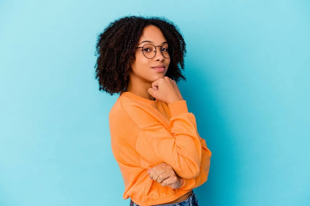 A cute female enjoying her terrific hair health after taking advantage of the many sea moss benefits for hair.