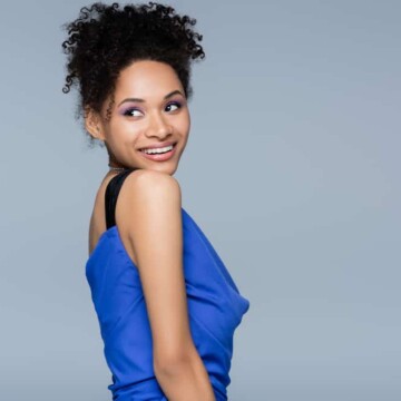 A beautiful African American female wearing a pineapple updo secured with hair clips during the hot summer season.