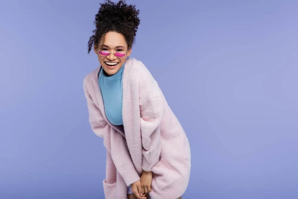 Black girl with a curly updo hairstyle created after washing her hair with a purifying shampoo.