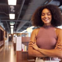 African American businesswoman with naturally brown hair that has red-brown shades after using Arctic Fox dye.