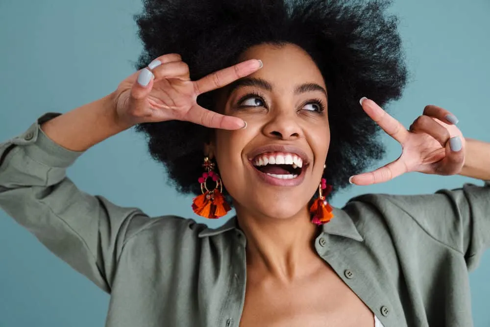 Cute African lady wearing her hair natural in a wash n go hairstyle while making a funny facial expression.