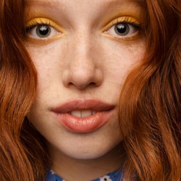 Young ginger white woman with an orange hair color after using a semi-permanent direct dye with copper tones.