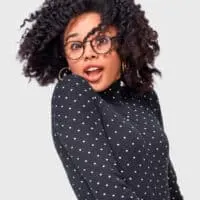 African American lady wearing a curly twist-out hairdo styled with organic tea tree oil.