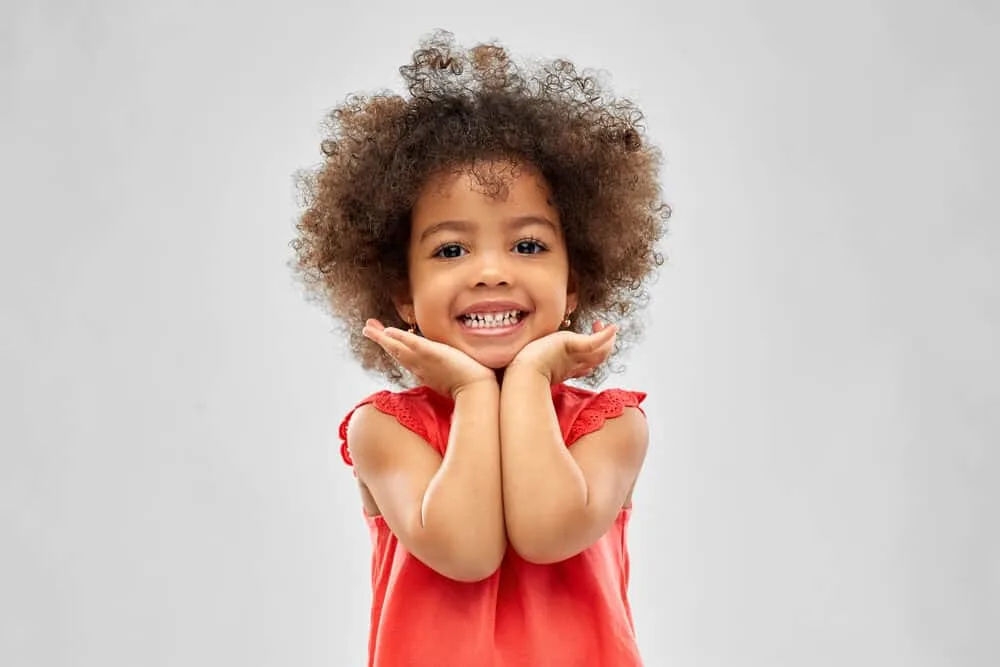 Cute little girl smiling after having a hair removed from her eye with a saline solution.