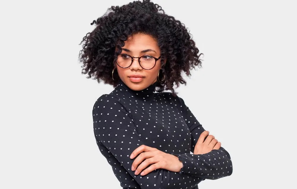 African American lady wearing a curly twist-out hairdo styled with organic tea tree oil products.