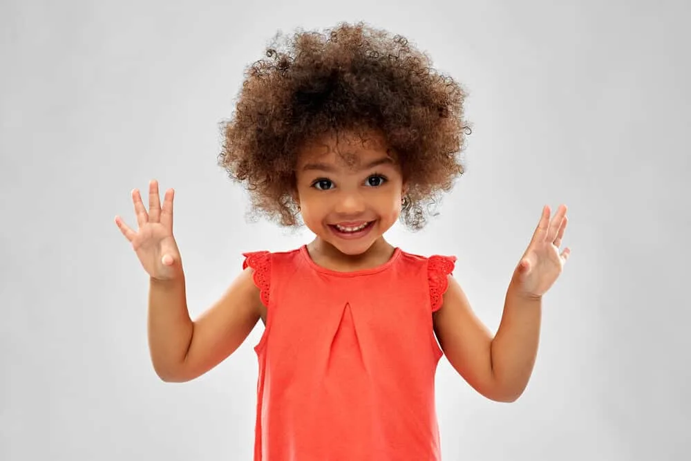 Cute toddler baby girl showing off her fingers as she learns to count.