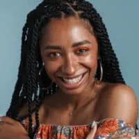 Gorgeous African American female with 4B natural hair follicles wearing her hair in a braided protective style.