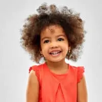 Adorable African American girl with a stray eyelash in her big black baby eyes that are stunning.