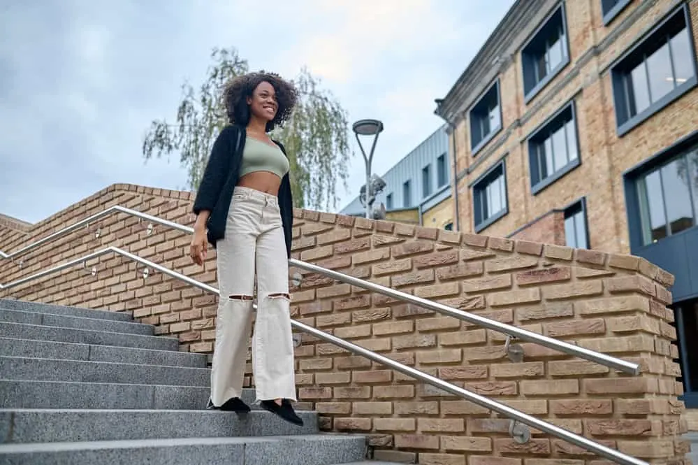 A stylish young African female wearing casual clothes and a high-quality wig.