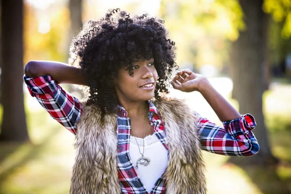 To alter her appearance, an adult woman with natural human hair is wearing an old-school 18th-century hair wig.