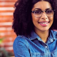 Cute African American female with a natural appearance wearing a low-maintenance hairpiece.