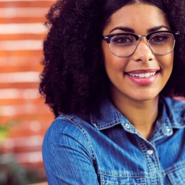 Cute African American female with a natural appearance wearing a low-maintenance hairpiece.