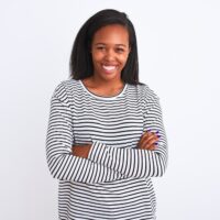 African American female with healthy hair after using a hair straightener and heat protectant on her thick hair.