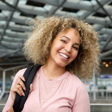 African American female with electric hair clippers and hair attachments in her carry-on luggage.