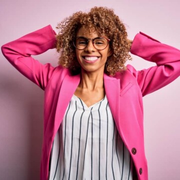 Young African American female wearing blonde semi-permanent hair color on her curly hair cuticles.