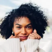 African American female with light brown skin color and dark hair after dyeing her dark brown with jet black hair dye.