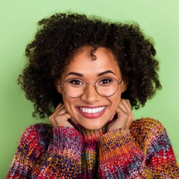 Gorgeous young woman with dark brown permanent hair color on her healthy hair strands.