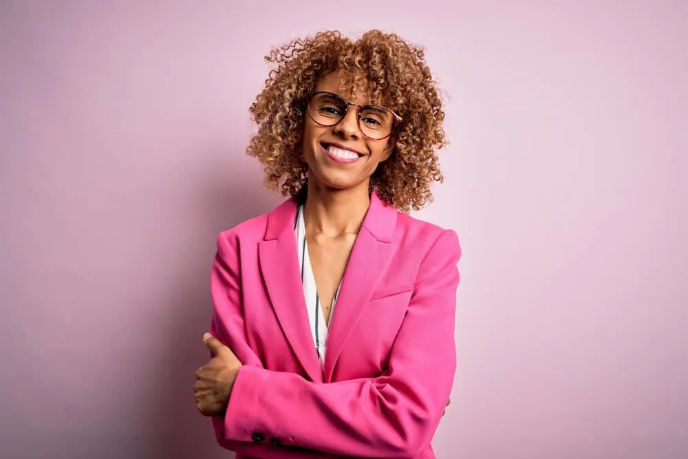 African American lady with brownish blonde hair color from using permanent hair dye chemicals.