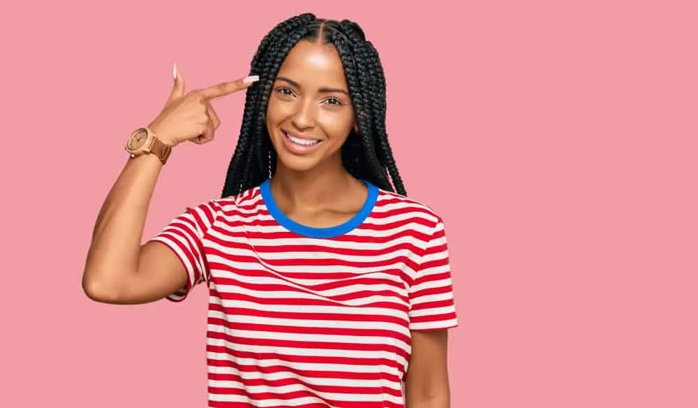 Light-skinned black woman wearing ancient tribal braids - a trendy style today in African American culture.