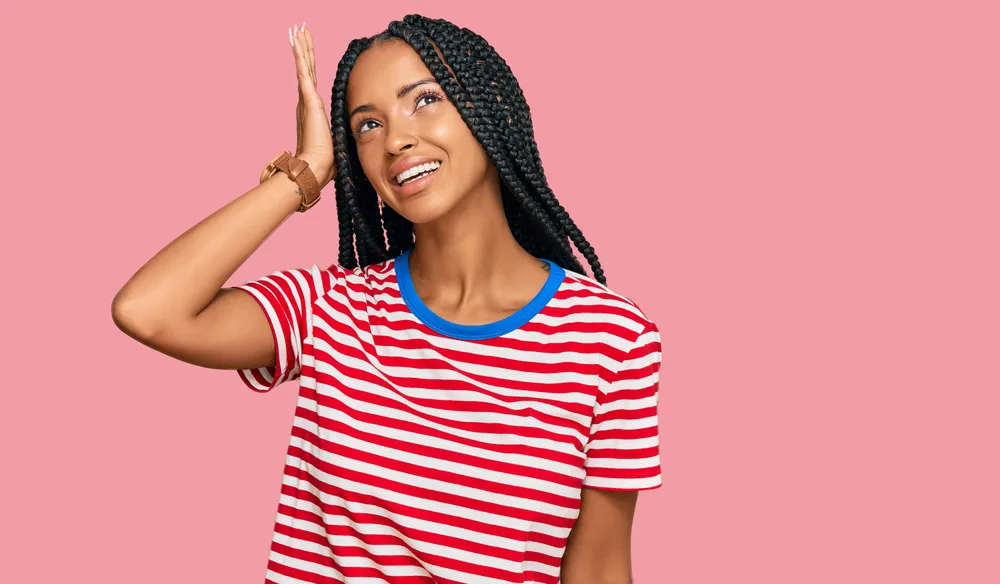 Pretty young black female wearing fulani braids - a traditional hairstyle with African American youngsters.