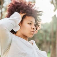 Beautiful African American female with naturally dark brown hair after getting a salon hair color treatment.