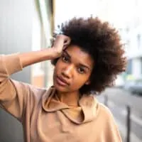 African American female with tangled hair knots and split ends on her 4C kinky natural hair.