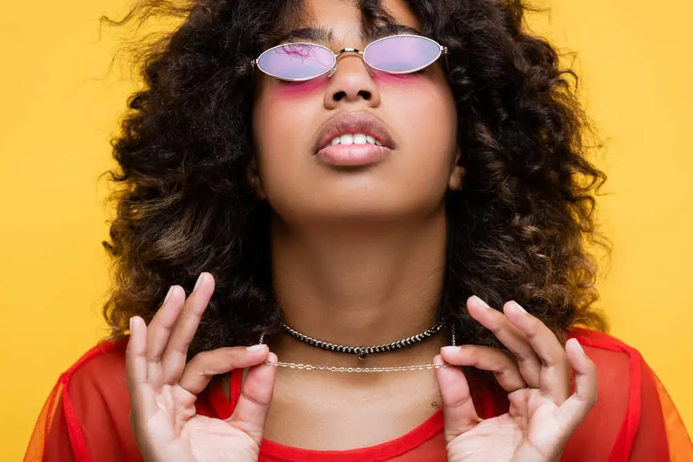 African American female after drying her wet hair with a hair dryer and styling it in a wash and go hairstyle.