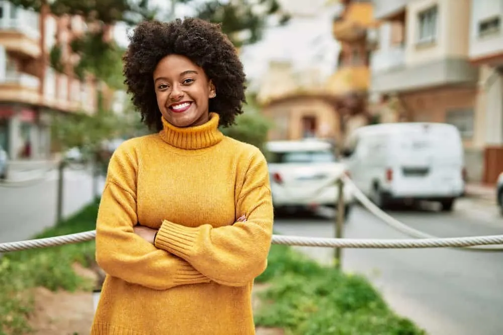 A lovely young black lady with dark hair wants to dye her curls a dark brown color since she's turning gray.