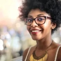 Cute African American female leaving a local salon after getting her hair styled by a professional hairdresser.